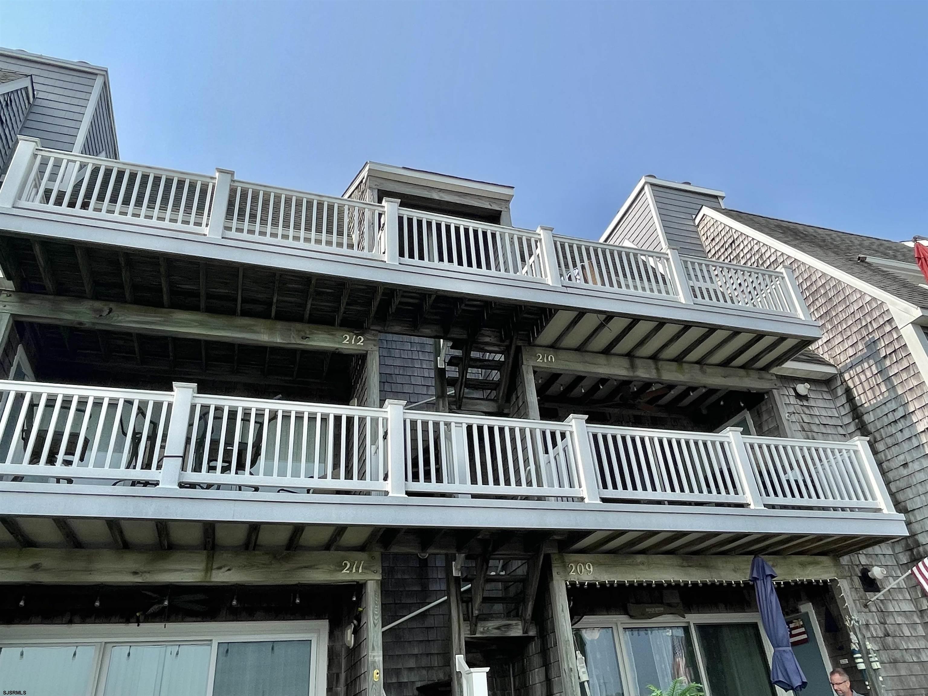 210 Harbour Cove, Unit 210 Somers Point, NJ 08244 - Photo 28 of 30 a view of a deck with a table and wooden floor