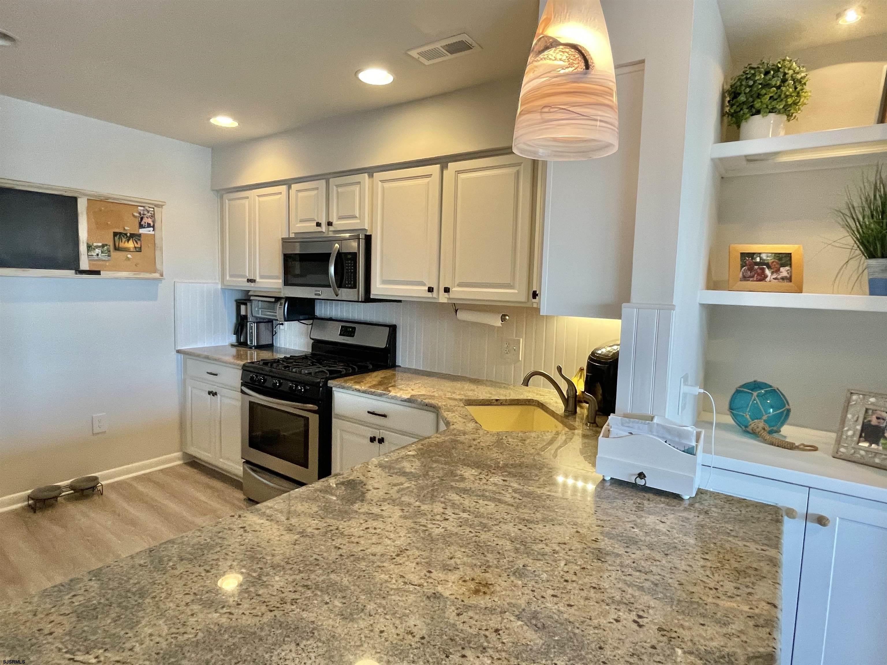 210 Harbour Cove, Unit 210 Somers Point, NJ 08244 - Photo 3 of 30 a kitchen with a stove and a refrigerator