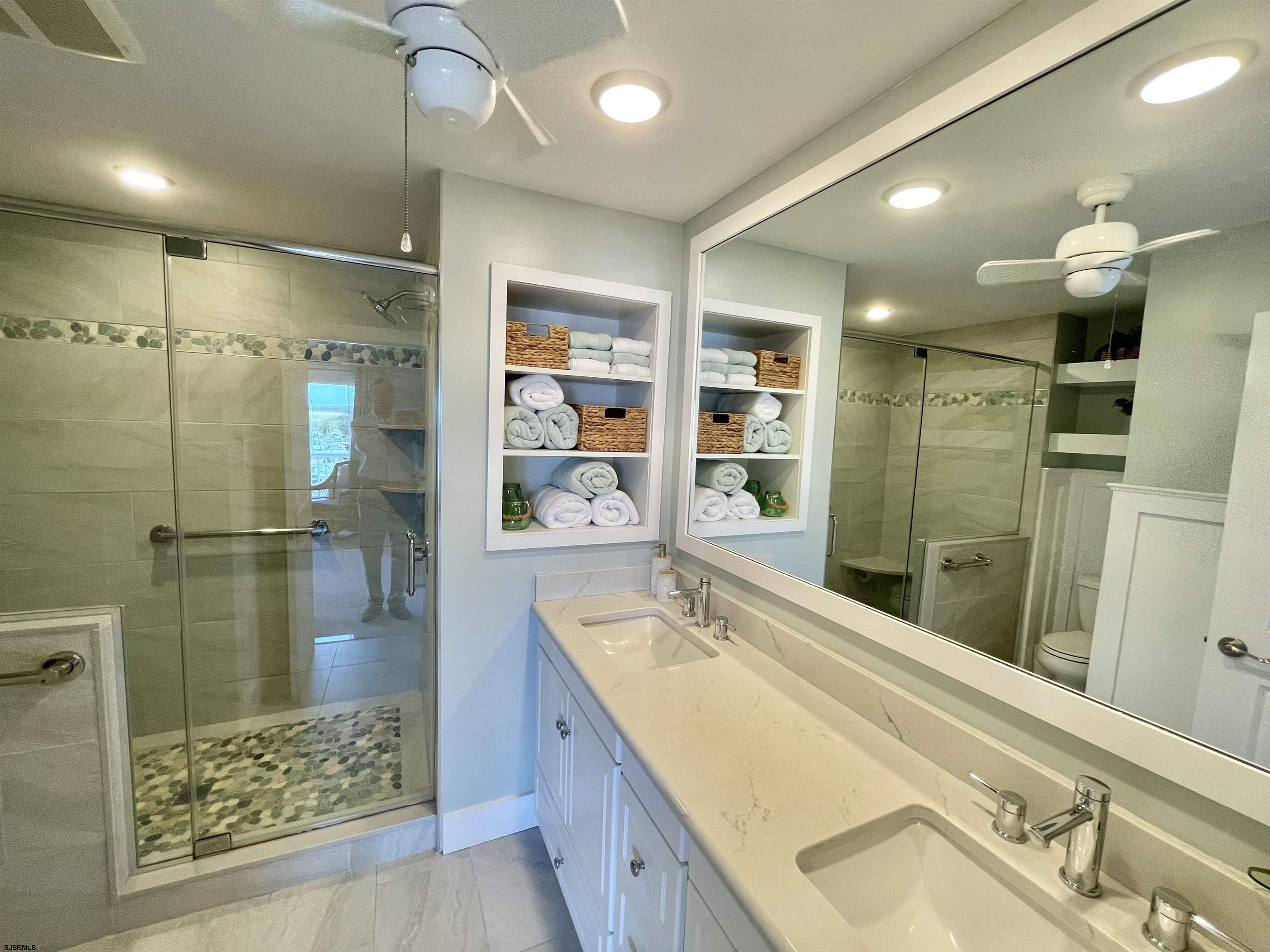 210 Harbour Cove, Unit 210 Somers Point, NJ 08244 - Photo 10 of 30 a bathroom with a tub sink shower and mirror