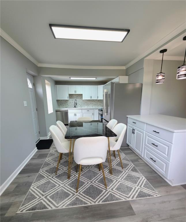 3581 Midway Road Decatur, GA 30032 - Photo 3 of 29 a kitchen with a dining table chairs and white cabinets