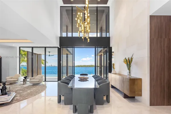 a dinning room with stainless steel appliances kitchen island granite countertop furniture and a window