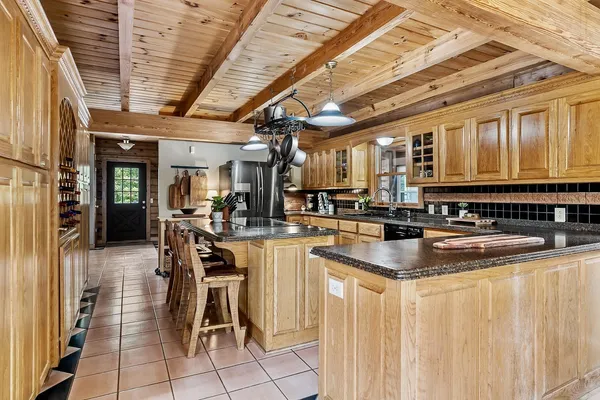 a kitchen with stainless steel appliances granite countertop a sink and a counter top space