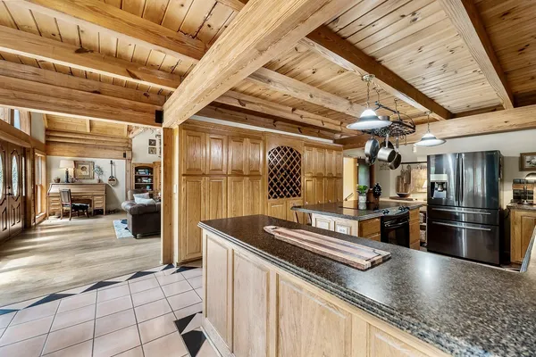 a kitchen with stainless steel appliances granite countertop a sink a stove and a refrigerator
