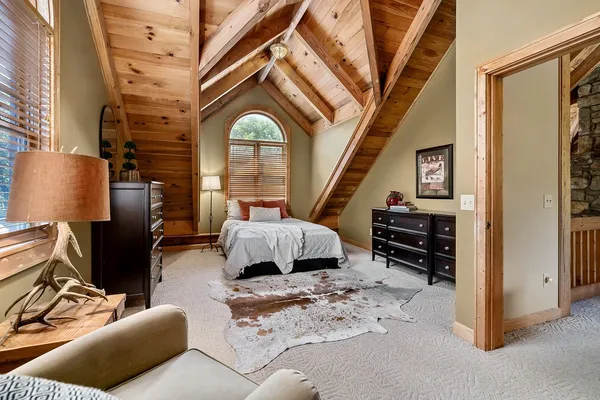 a bedroom with a bed and a mirror on the dresser