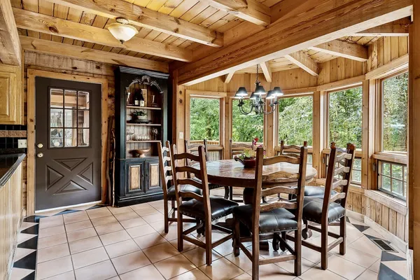 a view of a dining room with furniture and floor to ceiling window