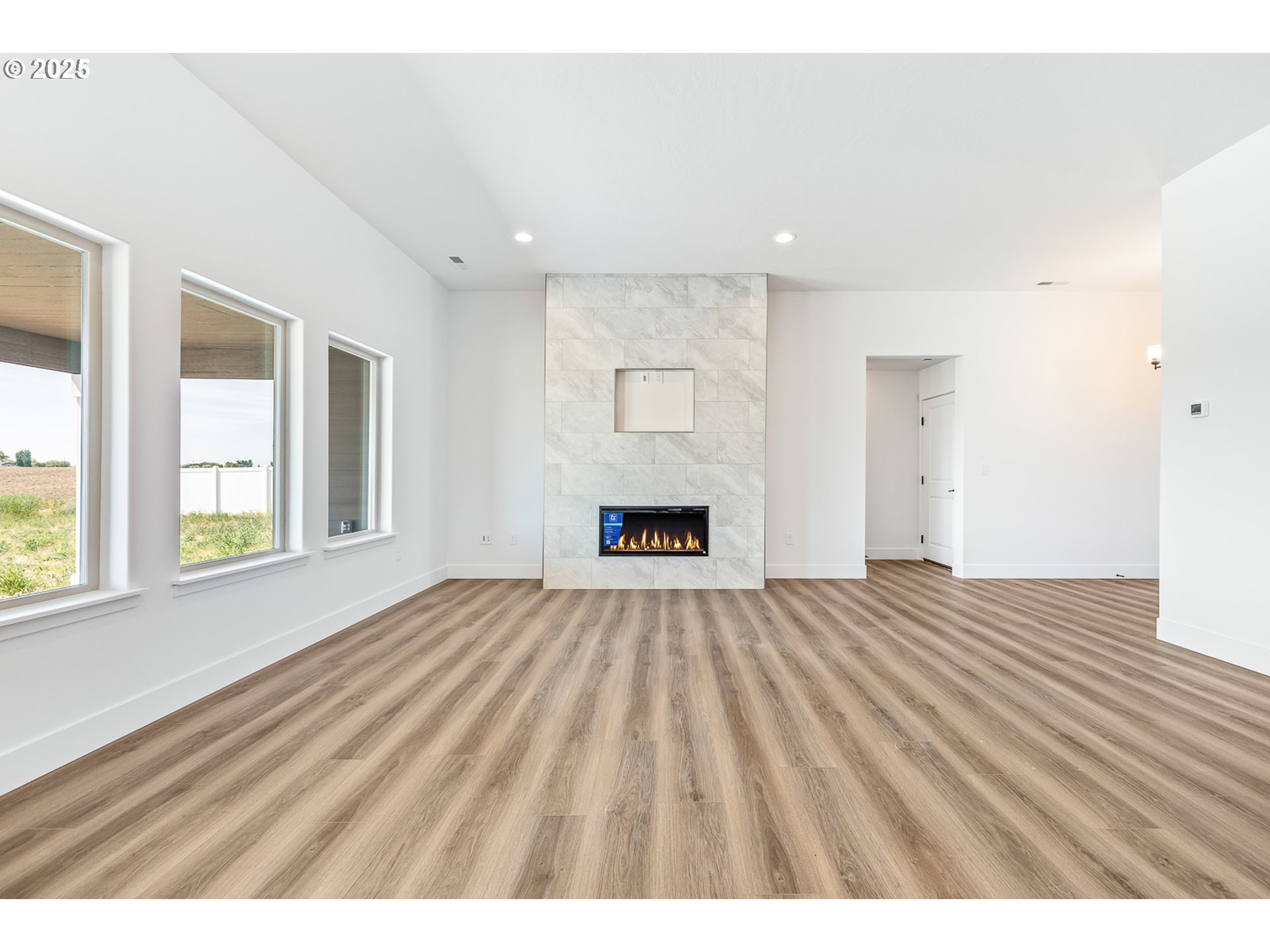 307 Sage Street Boardman, OR 97818 - Photo 11 of 25 a view of an empty room with wooden floor and a window