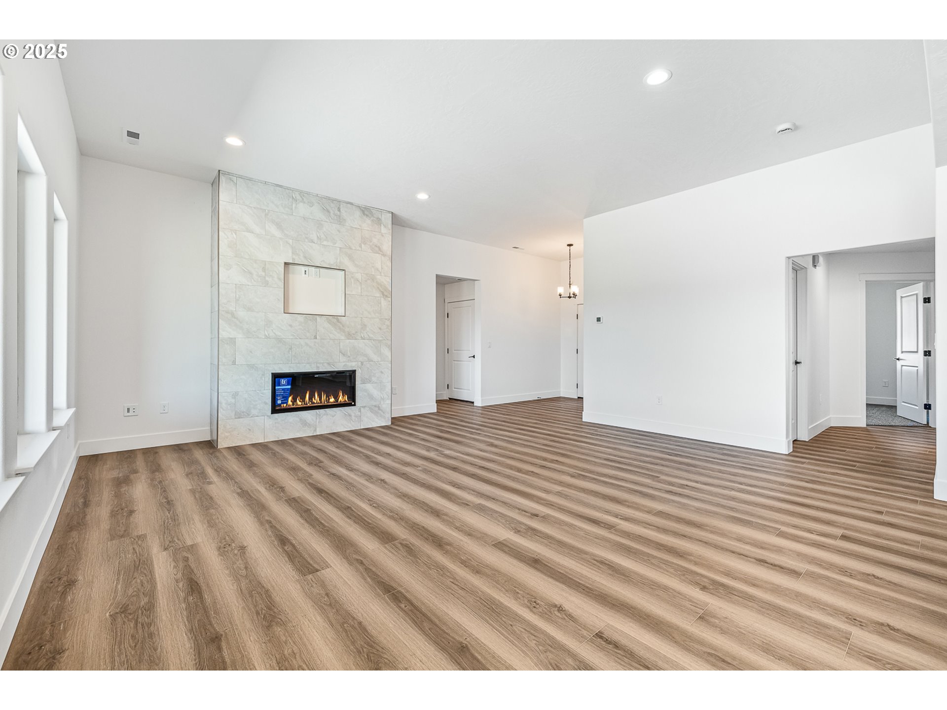 307 Sage Street Boardman, OR 97818 - Photo 12 of 25 a view of empty room with wooden floor and fireplace