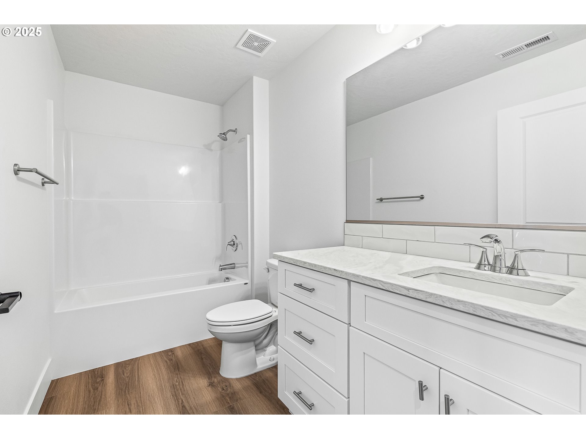 307 Sage Street Boardman, OR 97818 - Photo 17 of 25 a bathroom with a sink a toilet a mirror a bathtub and shower
