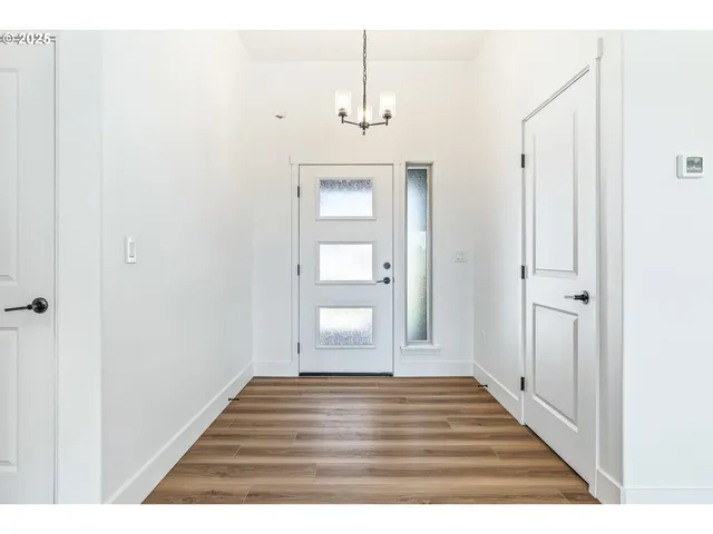 a view of a room with wooden floor and white wall