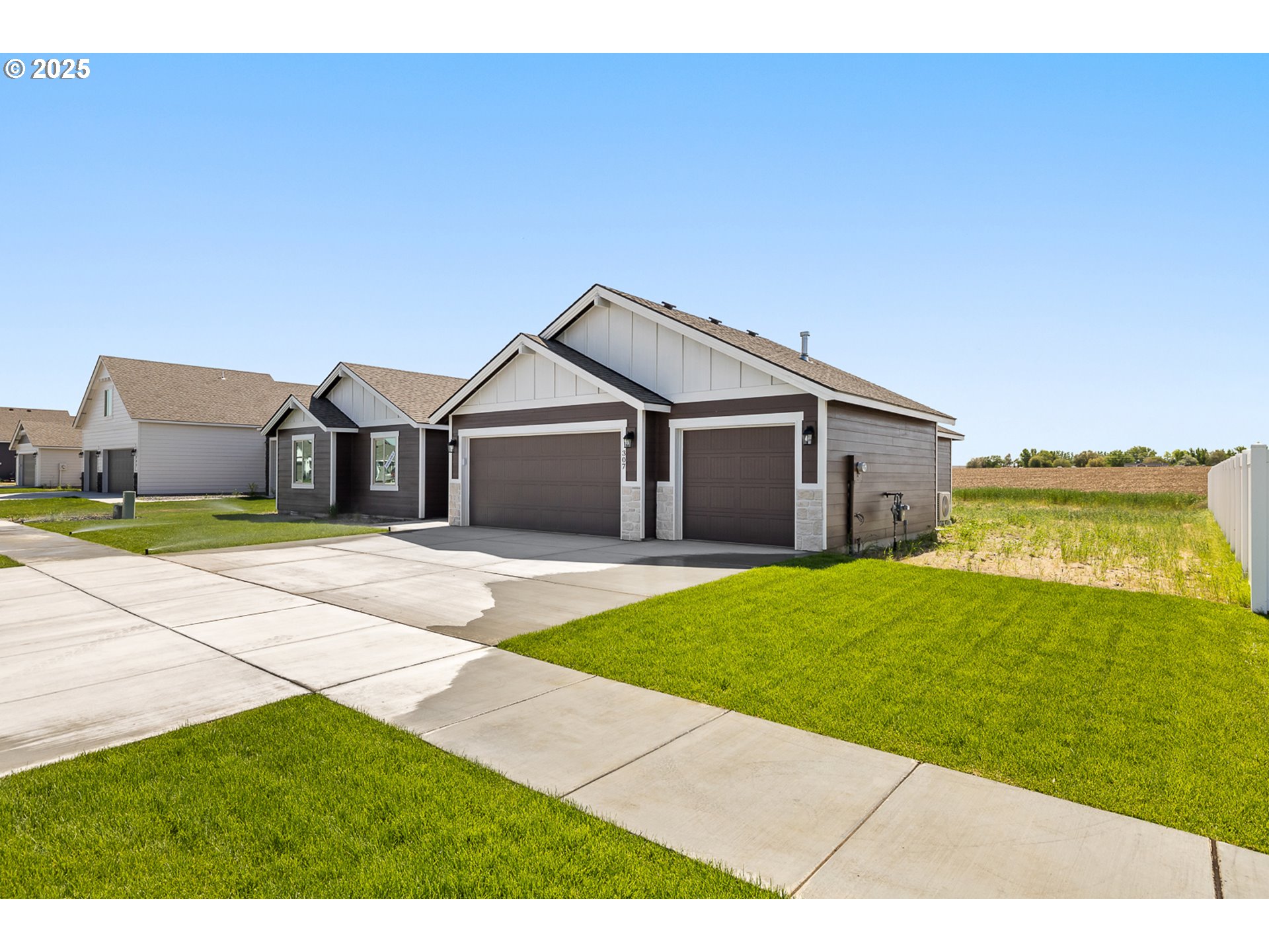 307 Sage Street Boardman, OR 97818 - Photo 21 of 25 a front view of a house with a garden and yard