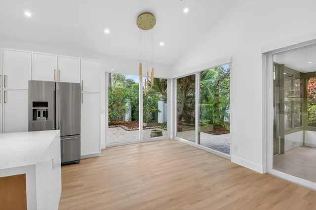 a view of kitchen with kitchen island and stainless steel appliances