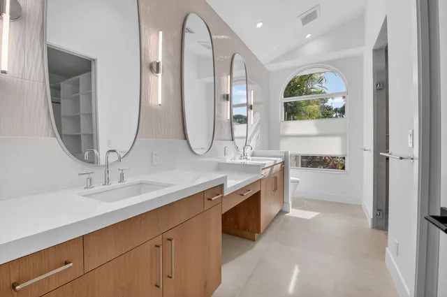 a bathroom with a double vanity sink a and mirror