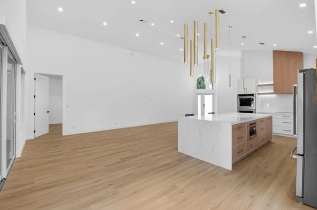 a kitchen with white cabinets appliances and sink