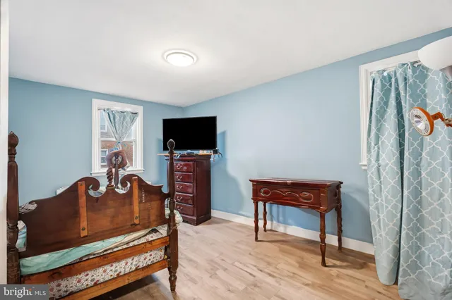 a bed room with furniture and wooden floor