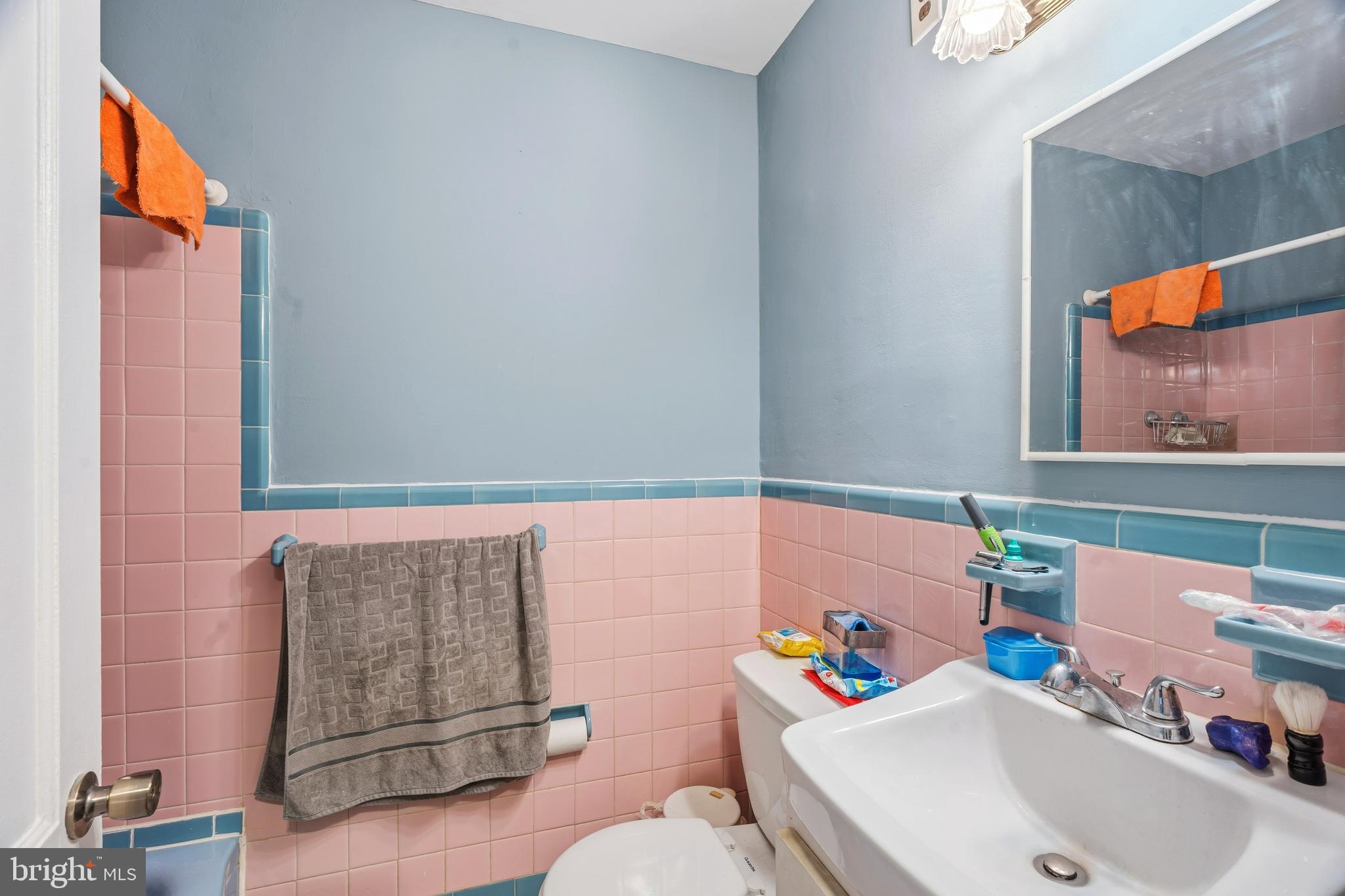 7318 Frontenac Street Philadelphia, PA 19111 - Photo 13 of 13 a bathroom with a sink mirror and toilet
