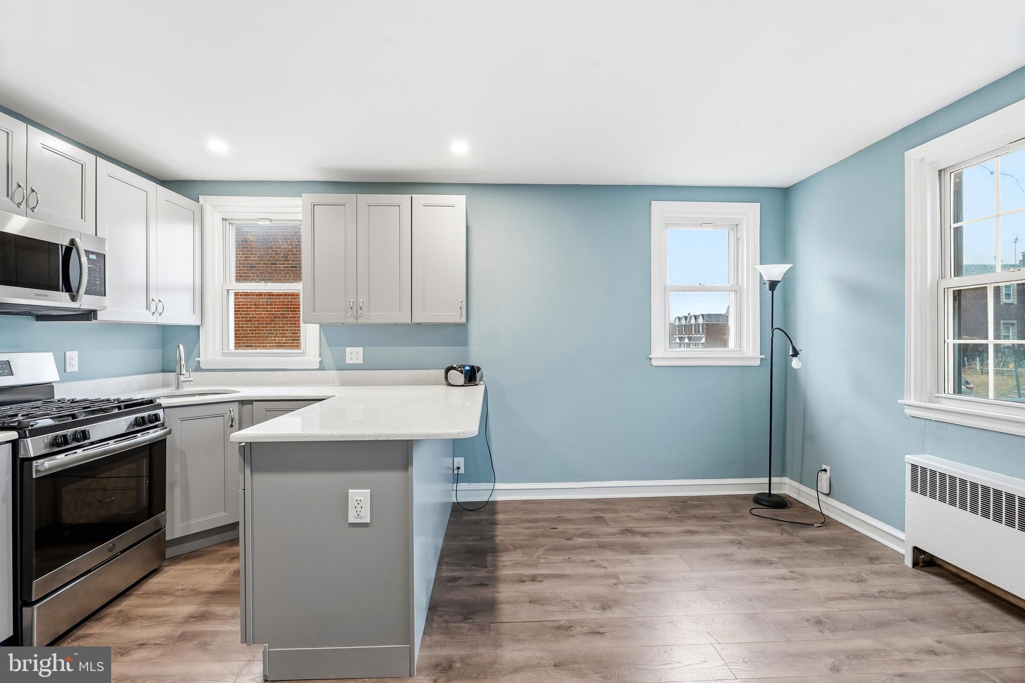 7318 Frontenac Street Philadelphia, PA 19111 - Photo 3 of 13 a kitchen with granite countertop a stove top oven sink and cabinets