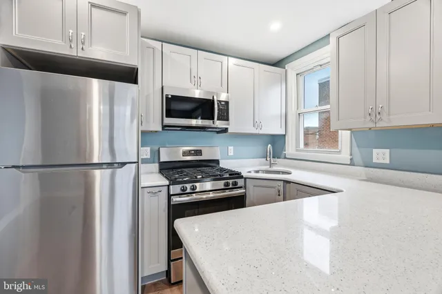 a view of hallway with walk in closet and bathroom