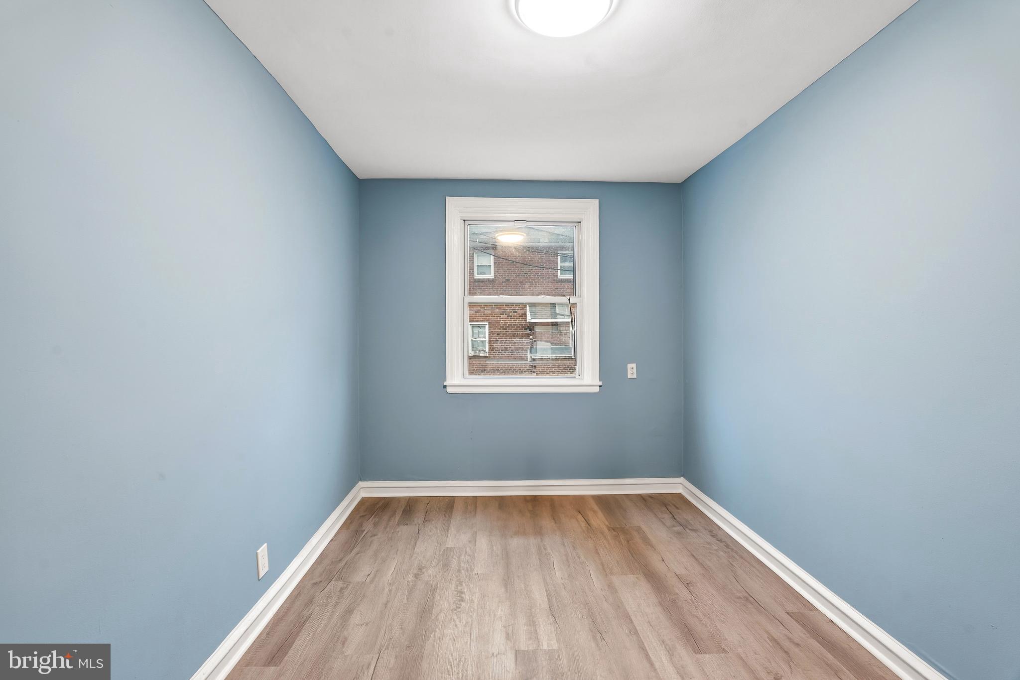 7318 Frontenac Street Philadelphia, PA 19111 - Photo 10 of 13 a view of an empty room with wooden floor and a window