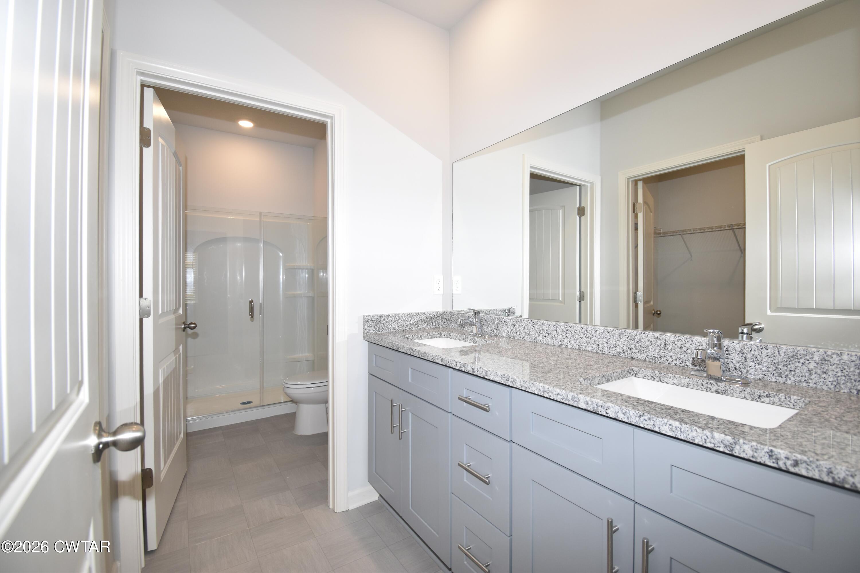 63 Clarendon Cove Jackson, TN 38305 - Photo 13 of 18 a bathroom with a granite countertop sink toilet and shower