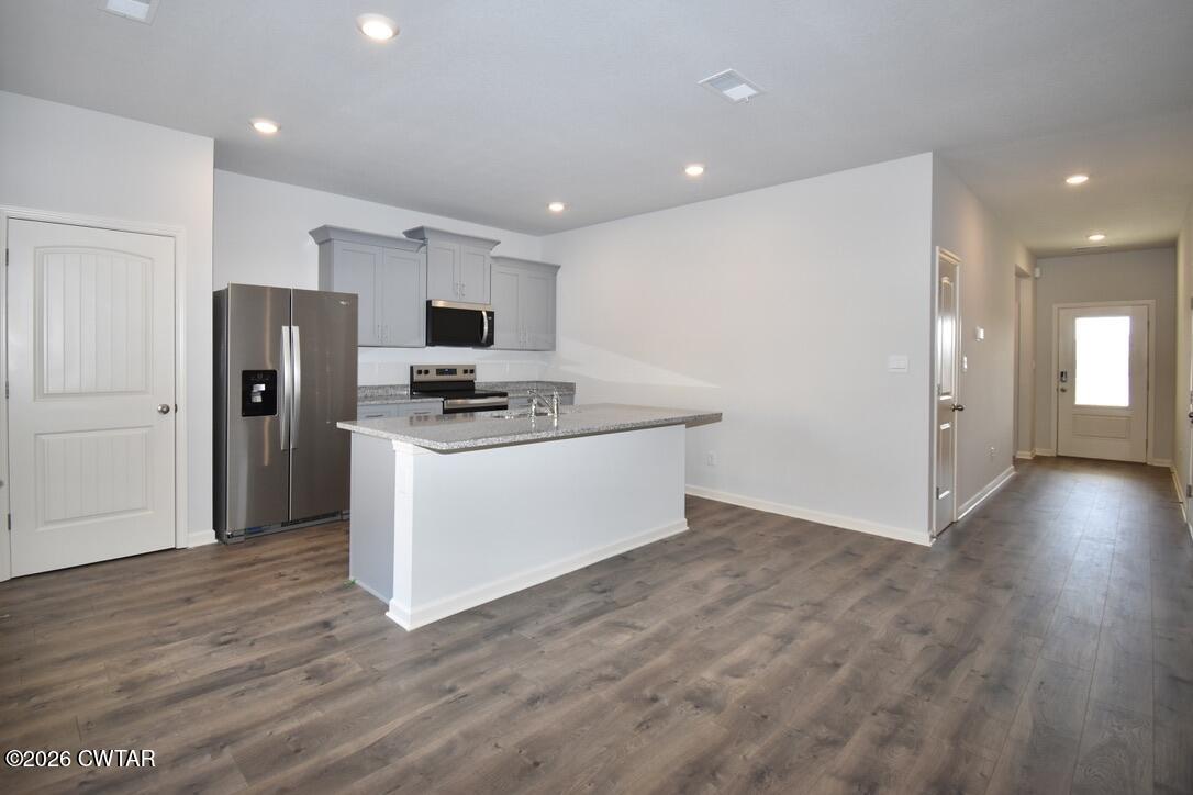 63 Clarendon Cove Jackson, TN 38305 - Photo 5 of 18 a view of kitchen with stainless steel appliances a refrigerator and a stove top oven