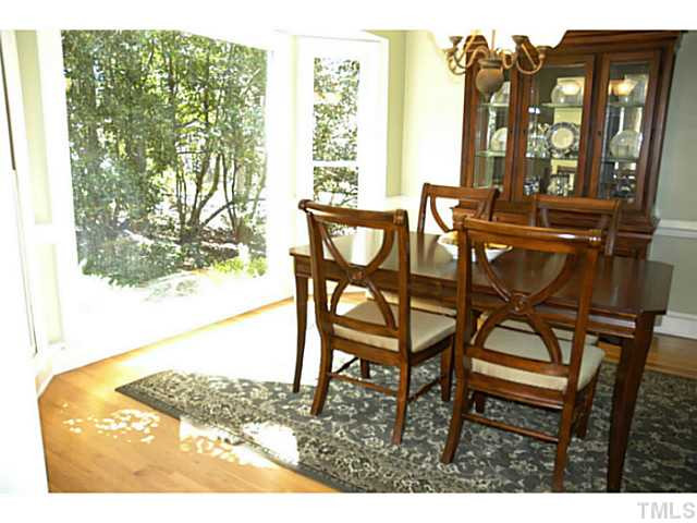 12613 Waterman Drive Raleigh, NC 27614 - Photo 4 of 25 Step into the foyer and to the left is the living room and gorgeous dining room. The gorgeous view in the picture window is fine art! Dining Room
