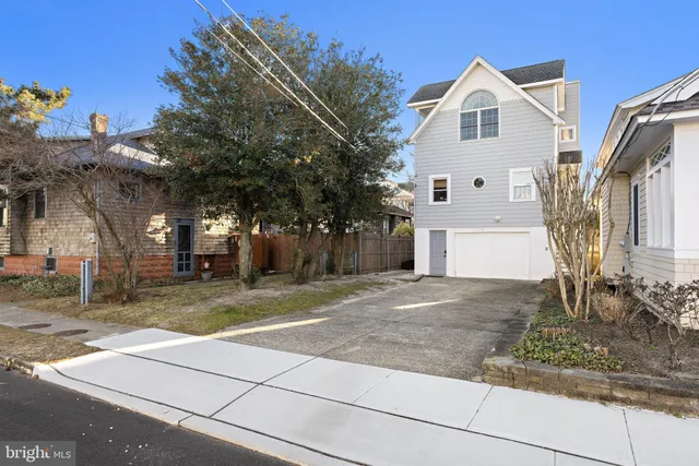 a view of a white house with a yard