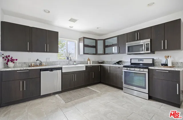 a kitchen with a sink stove top oven and microwave