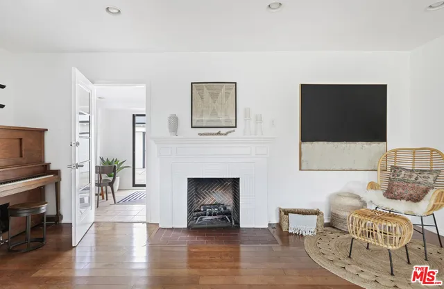 a view of a livingroom with furniture and floor to ceiling window
