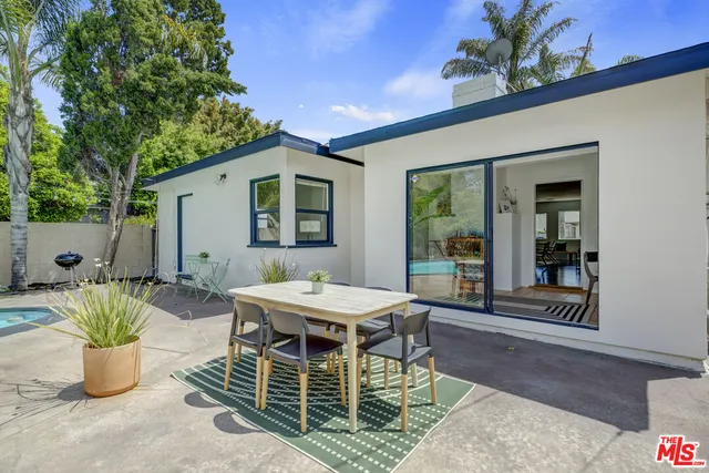 a bedroom with furniture and a large window