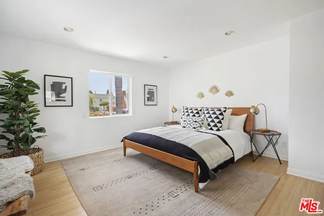 a bedroom with a bed and a couch