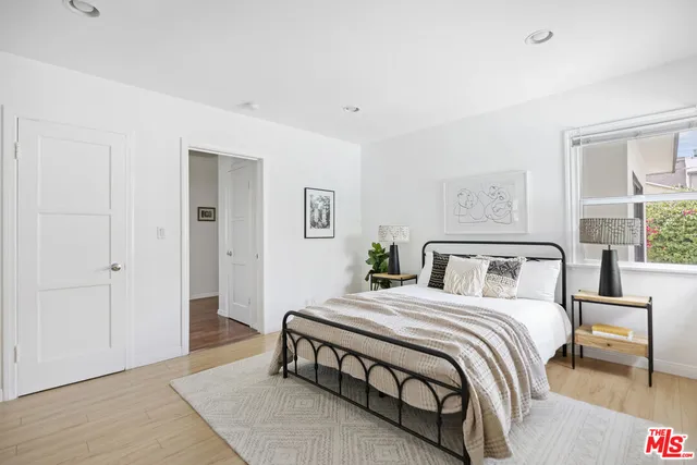 a bedroom with a large bed and a chandelier