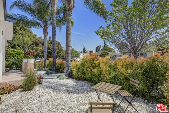 a view of a chair and table in the garden