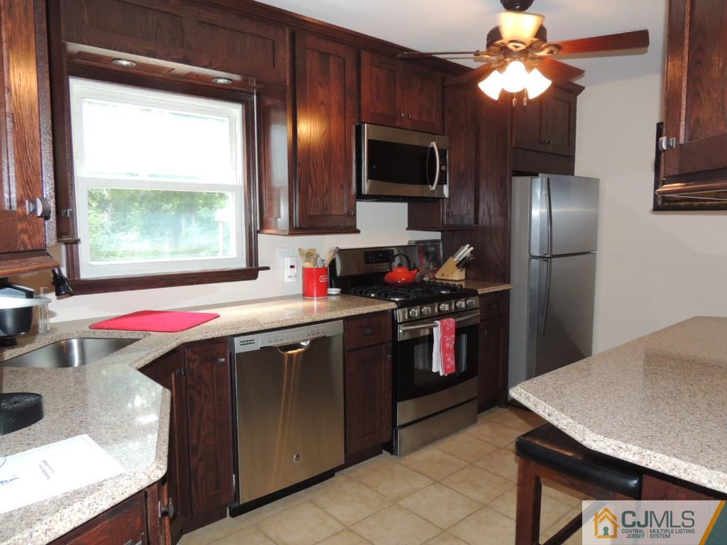 7 Channing Road East Brunswick, NJ 08816 - Photo 3 of 11 a kitchen with a stove a sink and a refrigerator