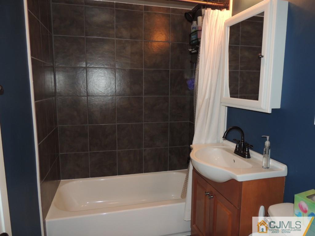 7 Channing Road East Brunswick, NJ 08816 - Photo 6 of 11 a bathroom with a bathtub and a sink