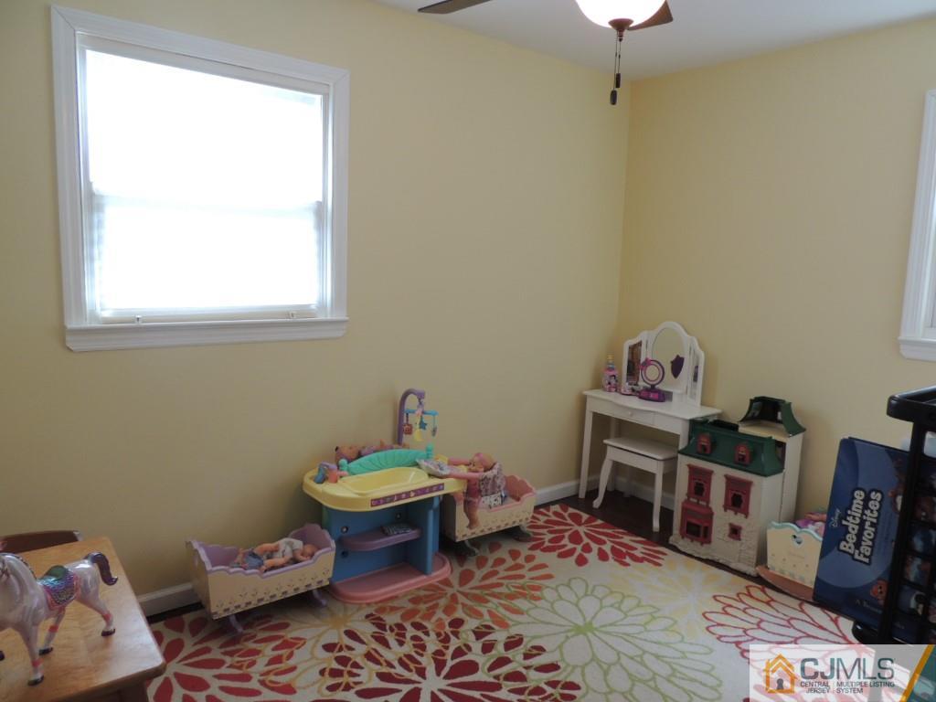 7 Channing Road East Brunswick, NJ 08816 - Photo 7 of 11 a reading room with furniture a rug and a window