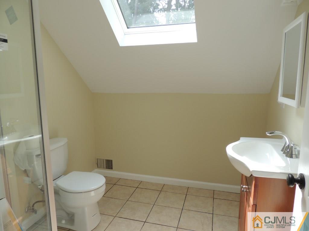 7 Channing Road East Brunswick, NJ 08816 - Photo 9 of 11 a white toilet sitting next to a bathroom sink