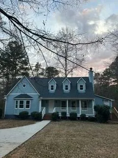 a view of a brick house with a big yard