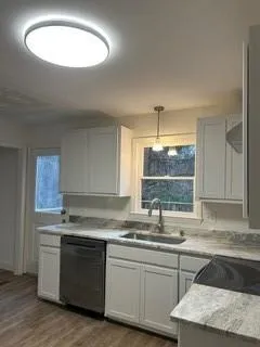 a kitchen with a sink stove and window