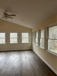 a view of room with hardwood floor and windows