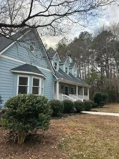 a front view of a house with yard and green space