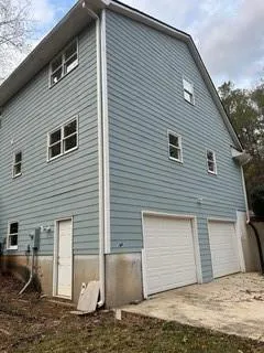a view of a house with a large tree