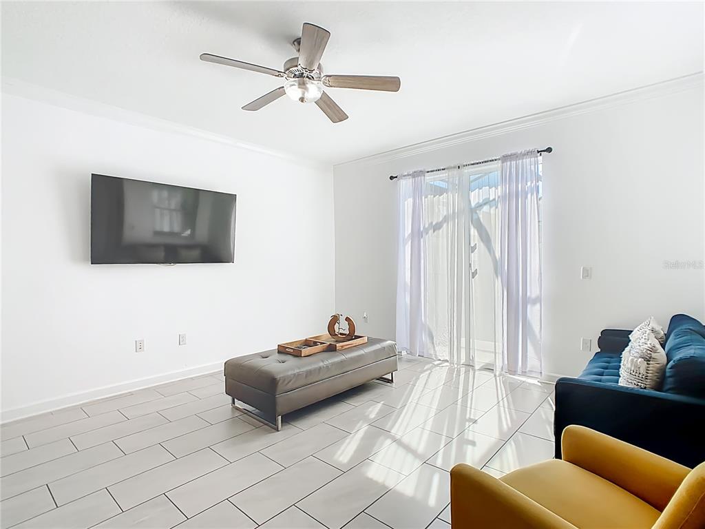 2957 Simile Street Kissimmee, FL 34746 - Photo 11 of 67 a living room with furniture and a flat screen tv