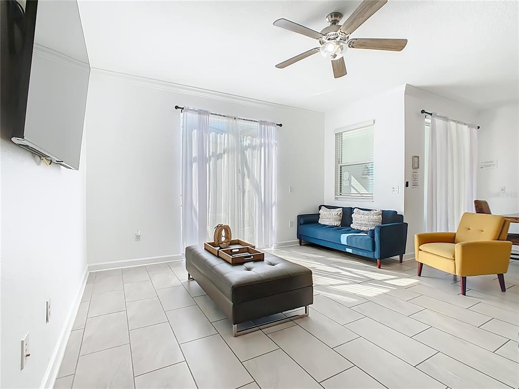 2957 Simile Street Kissimmee, FL 34746 - Photo 12 of 67 a living room with furniture and a flat screen tv