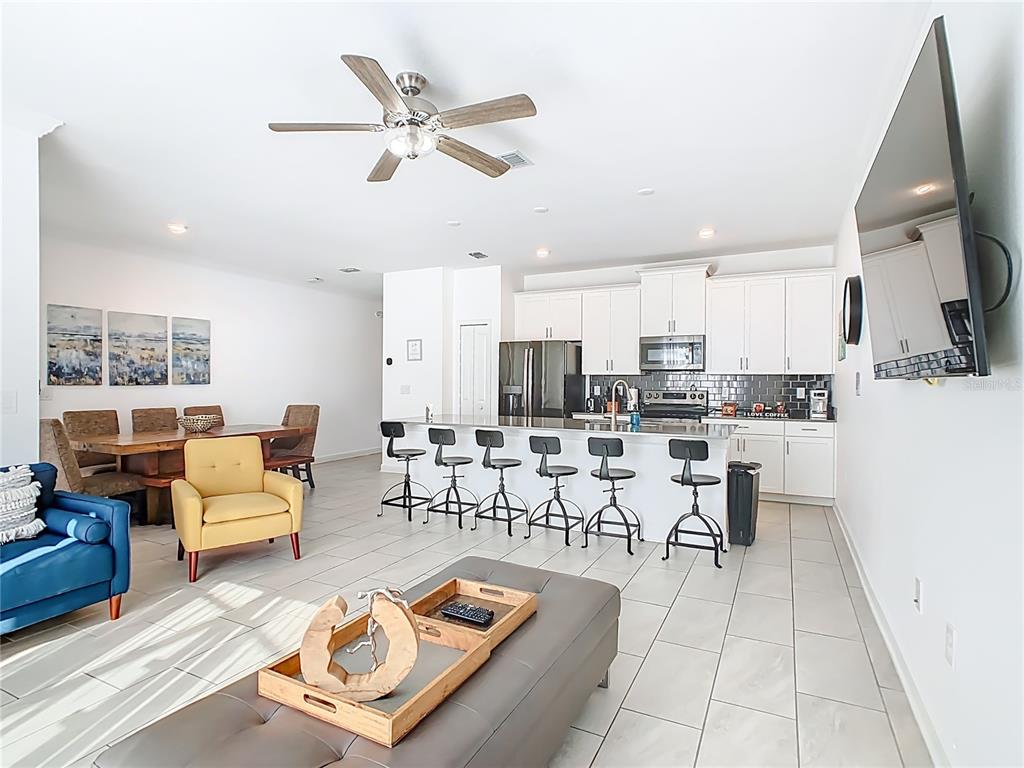 2957 Simile Street Kissimmee, FL 34746 - Photo 13 of 67 a living room with lots of furniture and a view of kitchen