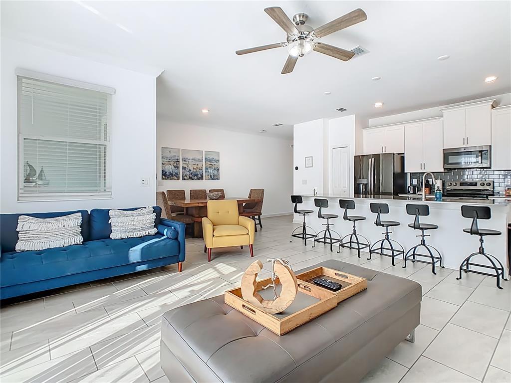 2957 Simile Street Kissimmee, FL 34746 - Photo 14 of 67 a living room with furniture and view of kitchen