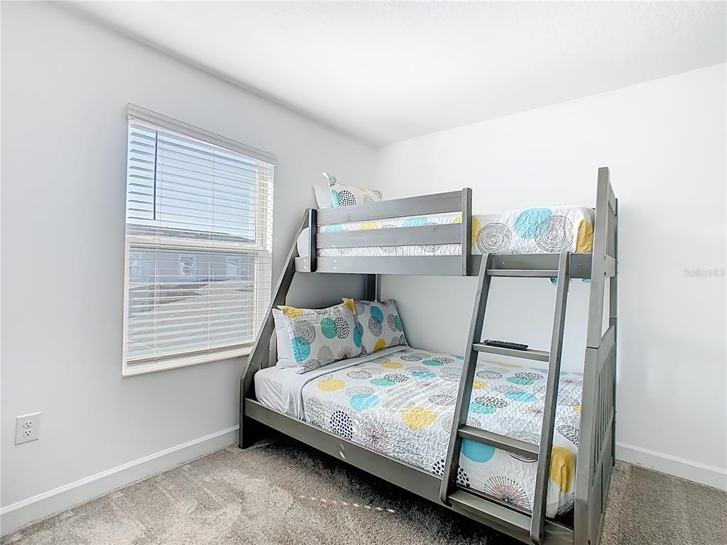 2957 Simile Street Kissimmee, FL 34746 - Photo 19 of 67 a bedroom with a bed and a window