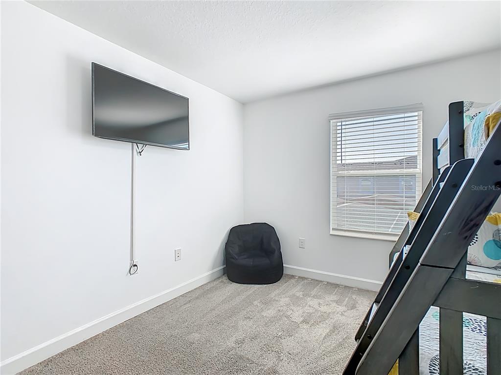 2957 Simile Street Kissimmee, FL 34746 - Photo 20 of 67 a living room with furniture and a flat screen tv