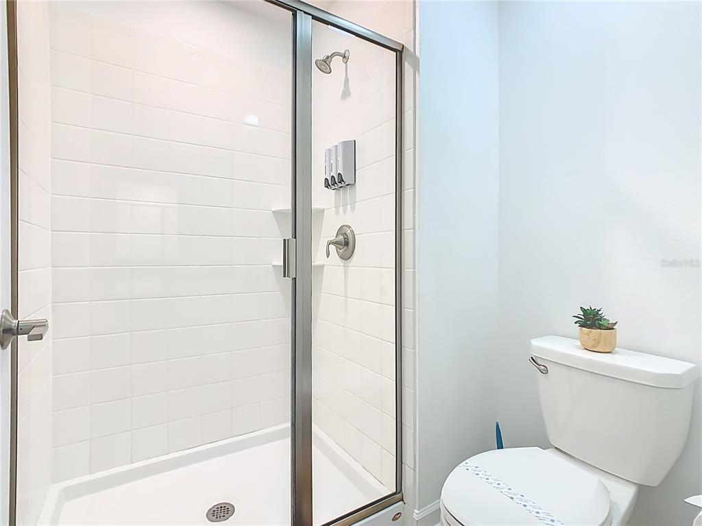 2957 Simile Street Kissimmee, FL 34746 - Photo 21 of 67 a white toilet sitting next to a bath tub