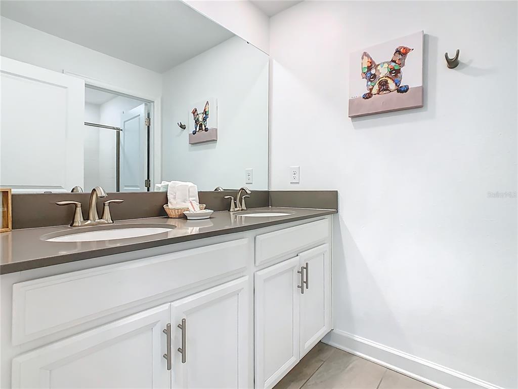 2957 Simile Street Kissimmee, FL 34746 - Photo 24 of 67 a bathroom with a sink and a mirror