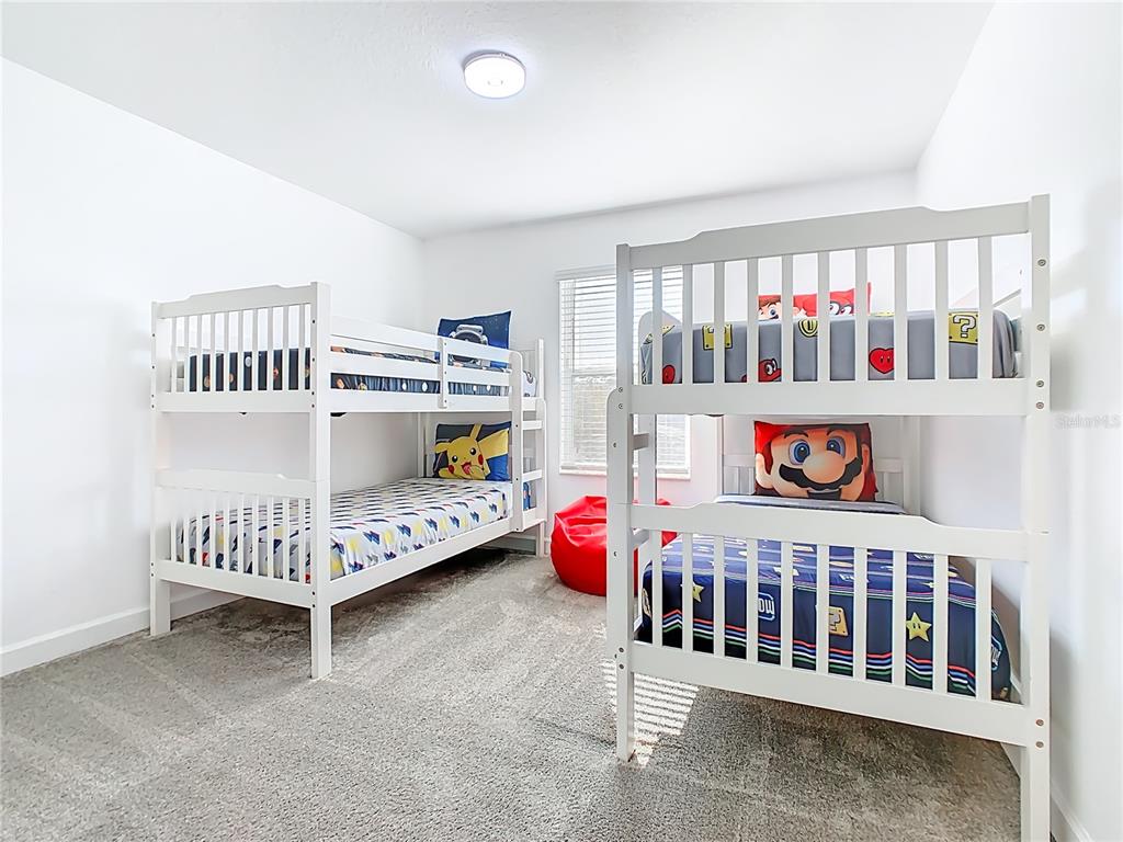 2957 Simile Street Kissimmee, FL 34746 - Photo 25 of 67 a bedroom with furniture and baby crib